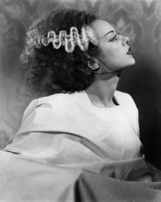 a black and white photo of a woman with curly hair