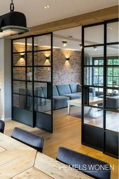 a living room filled with furniture next to a window covered in frosted glass doors