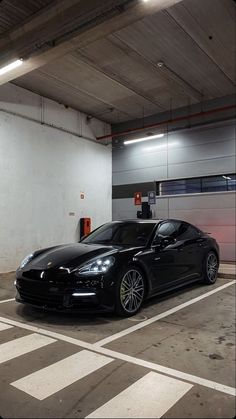 a black sports car parked in a parking garage