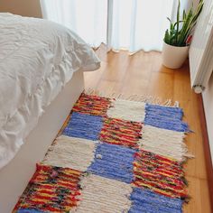 a white bed sitting on top of a wooden floor