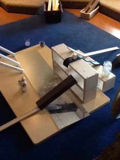 a table with some tools on it and a blue rug in front of the table