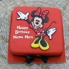 a red birthday cake with a minnie mouse design on it's face and name