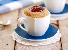 two cups filled with food sitting on top of a blue and white saucer next to each other