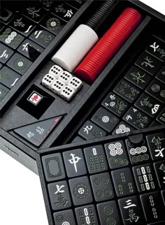 two black calculators with dices and playing cards on the top one is red