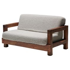 a wooden frame couch with a light colored upholstered seat