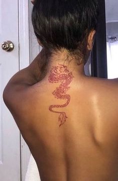 a woman with a dragon tattoo on her back