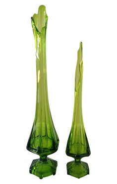 two green glass vases sitting next to each other