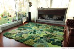 a living room with a large rug on the floor and a fire place in the corner