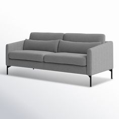 a gray couch sitting on top of a white floor