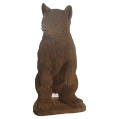 a statue of a bear sitting on its hind legs