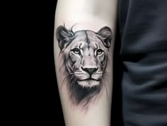 a man's arm with a black and white tattoo of a lion on it