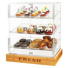 three tier acrylic display case with cupcakes and muffins