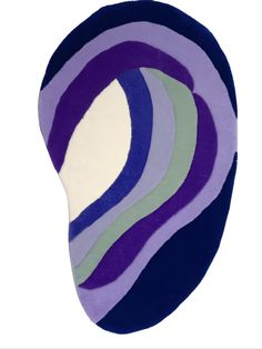 a purple, blue and green rug on a white background with an oval design in the middle