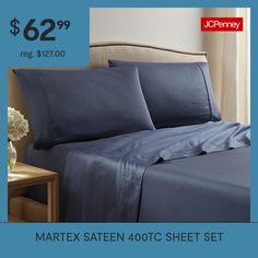 an image of a bed with blue sheets and pillowcases on the sale sheet set