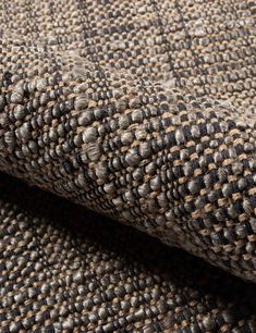 close up view of the texture of a tweed fabric