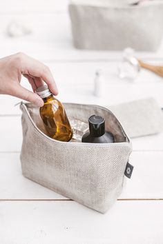 a person is holding a bottle in a bag