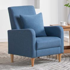 a blue chair sitting on top of a rug