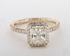 an engagement ring with a cushion cut diamond in the center