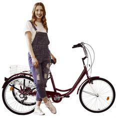 a woman standing next to a red bike with basket on the front and back wheels