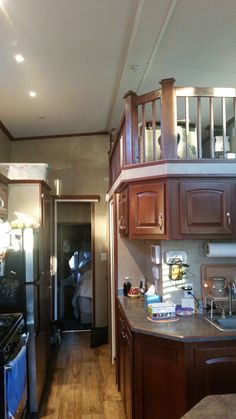 a kitchen with wooden cabinets and stainless steel appliances