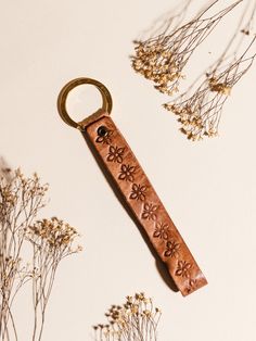 a leather key chain with flowers on it