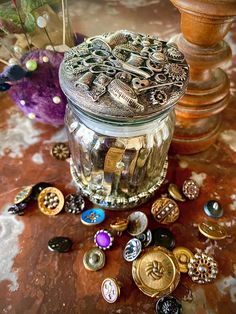 a jar filled with lots of different types of buttons