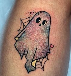 a tattoo with a ghost on the side of it's leg, and hearts in the background