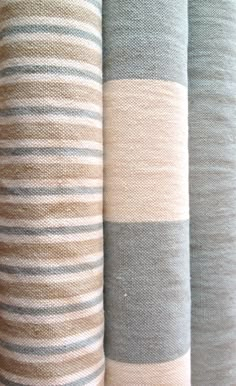 four different colored striped fabrics are lined up