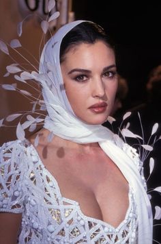 a woman in a white dress and head scarf