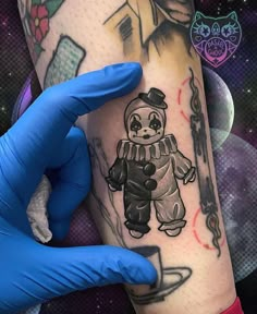 a person wearing blue gloves holding up a tattoo