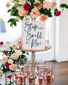 an image of a cake with wine glasses on it and flowers in the bottom right corner