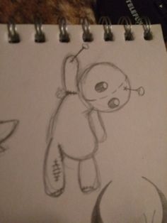 a drawing of a teddy bear on a notepad