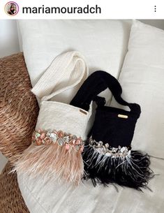 two purses sitting on top of a white couch