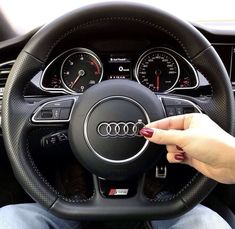 a woman is holding the steering wheel in her car