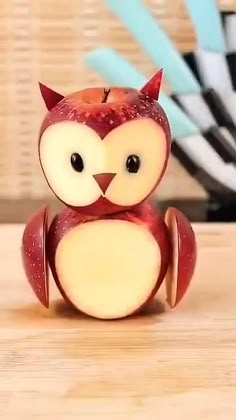 an apple shaped like an owl sitting on top of a table