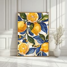 an art print with lemons and leaves on a white wall next to a vase