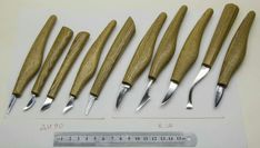 five different types of wood carving tools on a white surface with numbers and measurements in the background