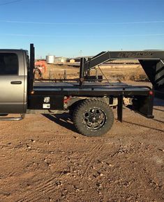 the truck is parked in the dirt by itself