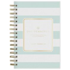 a blue and white striped notebook with gold foil on the front, featuring an elegant frame