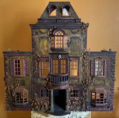 a doll house with lots of windows and doors