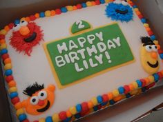 a birthday cake with sesame street characters on it