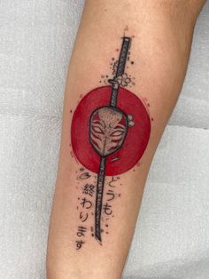 a tattoo on the leg of a person with a knife and blood splatter