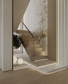 an empty room with some stairs and a potted plant on the floor next to it