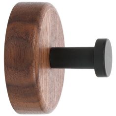 a close up of a hook on a wooden door handle with black metal knobs