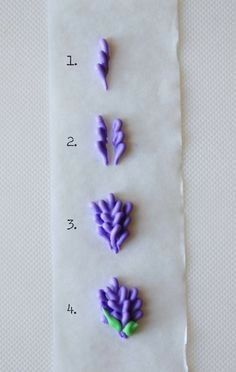 three purple flowers are sitting on a piece of paper with the numbers 1 - 2