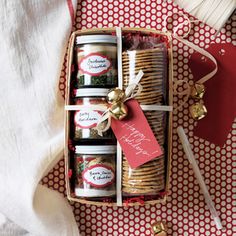 a basket filled with lots of different items on top of a red and white table cloth