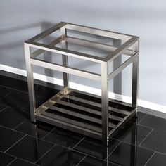 a metal and glass side table on tiled floor