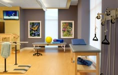 a room filled with lots of different types of exercise equipment and decor on the walls