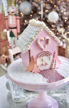 a pink cake with white icing and decorations