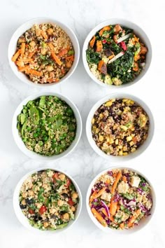 six white bowls filled with different types of food on top of a marble countertop